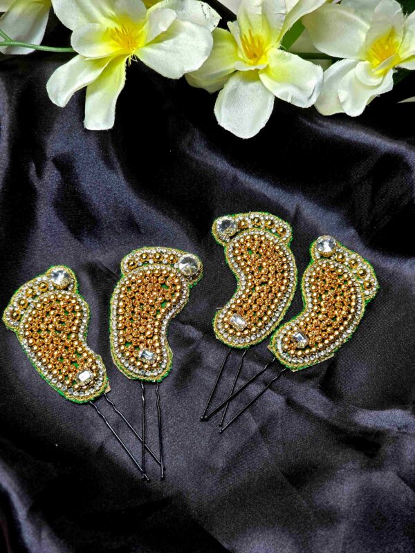 Footprint Brooches - Elegant Saree Accessories Footprint-shaped brooches in metallic finish