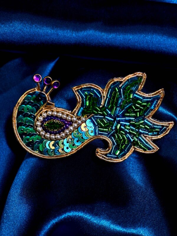 Peacock design saree pin with colorful enamel and decorative detailing